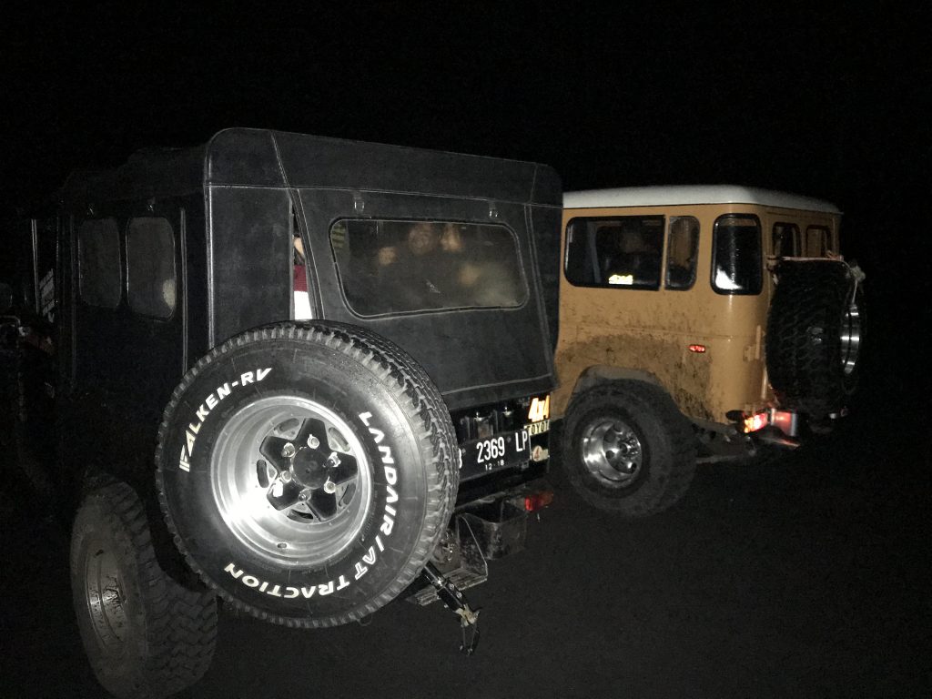 Picture of two jeeps in the dark