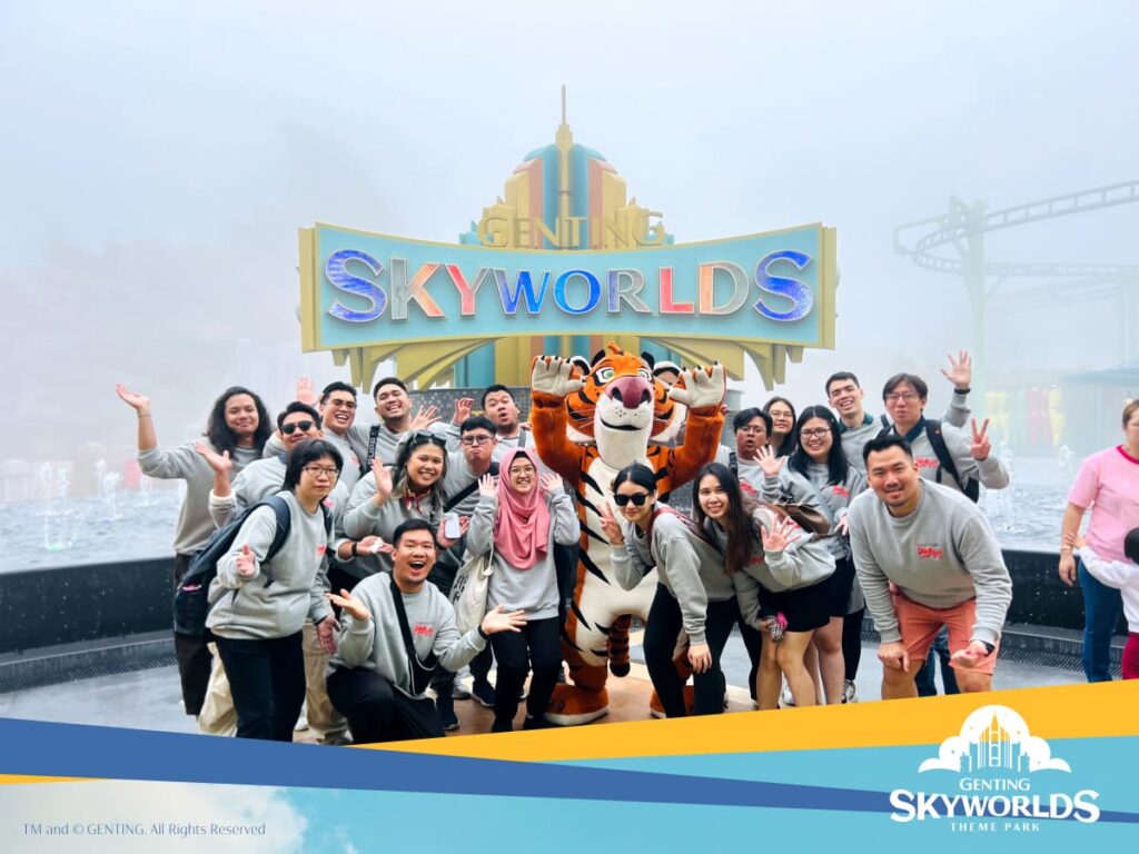 Group photo in front of the SkyWorlds logo.